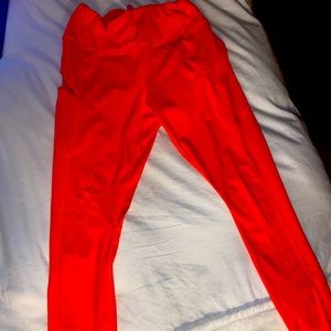 neon orange athleta pants, with side pocket